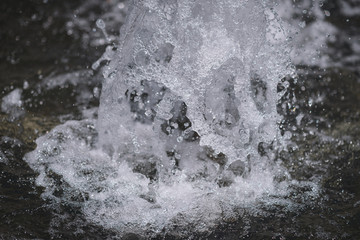 City fountain. Selective focus on water drops.