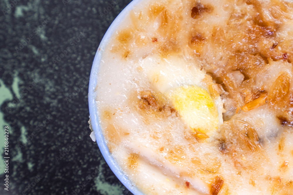 Wall mural Taiwan's distinctive famous snacks: Savory rice pudding (Wa gui) in a white bowl on stone table, Taiwan Delicacies, Taiwan Street Food