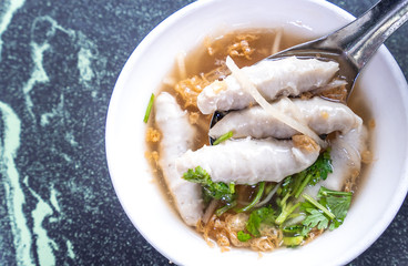Taiwan's distinctive famous snacks: fish meatball potage soup in a white bowl on stone table, Taiwan Delicacies, Taiwan Street Food