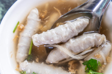 Taiwan's distinctive famous snacks: fish meatball potage soup in a white bowl on stone table, Taiwan Delicacies, Taiwan Street Food
