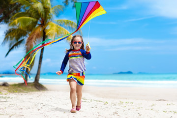 Child with kite. Kids play. Family beach vacation.