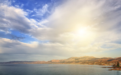 Panorama of Hersonissos town, with beautiful sunset clouds and sun resort in Crete, Greece