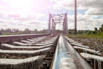 Fototapeta premium railroad rail close-up and sunset in the background