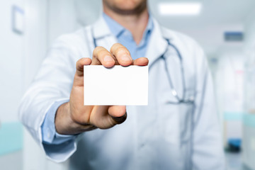 doctor showing blank business card