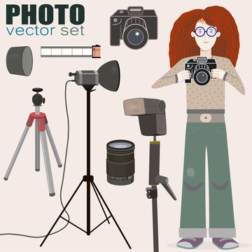Nice collection of photo equipment (camera, film 35mm, flash, lightning equipment, lens, lens hood, tripod) and a bonus - red-haired girl photographer! Suitable for web or printed production.  