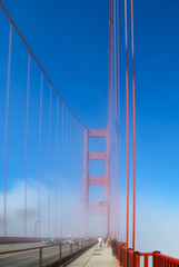 San Francisco Golden Gate bridge traffic on foggy day dramatic evening light