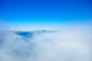 Fototapeta premium Marin headland and San Francisco bay on foggy day with clear blue sky