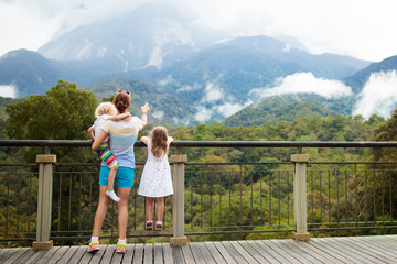 Fototapeta na wymiar Family with kids looking at mountain.