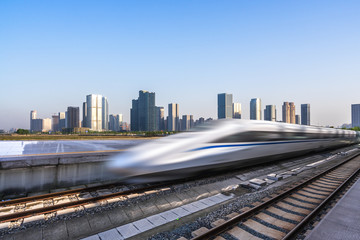 Fototapeta na wymiar high speed train with city skyline