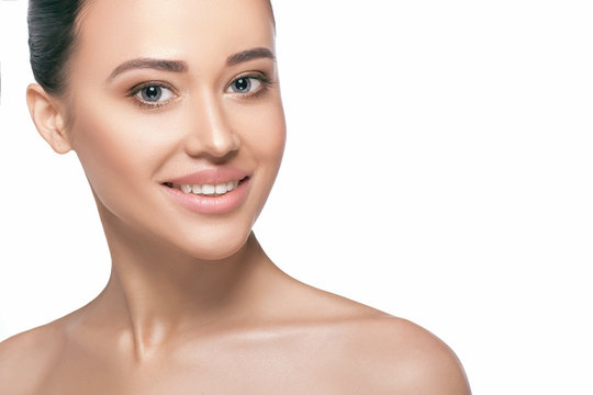 Studio shot of young smiling beautiful woman on white background. Portrait of women with perfectly clean and fresh skin, cosmetology and esthetic facial care