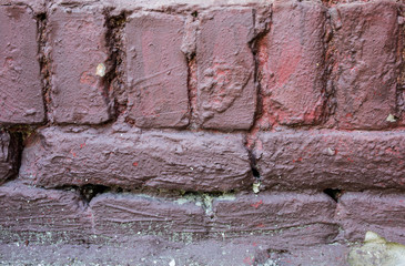 Old  painted bricks wall texture background outdoors. Vintage wall.