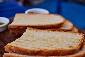 Gourmet Italian snack, restaurant menu ,food photo concept. Chef's olive tapenada and crunchy rye baguette in restaurant serving.