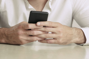 Close up view of mobile phone in hands, studio shot