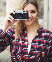 Young blonde woman with retro camera