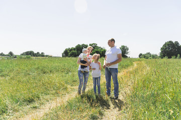 Family walks in the field. Family with soap bubbles. A family with two children. A full-fledged family.