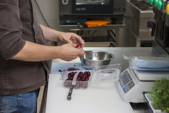 Cook extracts bones from cherry berries