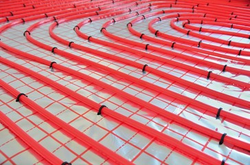 Close-up of water underfloor heating pipes on the silver reflective foil.