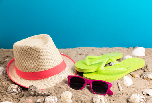flip flops with sunglasses and strand hat