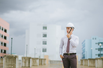  Handsome engineer standing on a tall building.