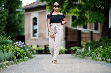 Stylish african american woman at sunglasses posed outdoor.