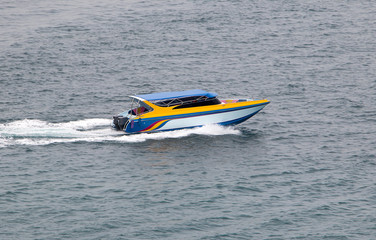 A motorboat rides quickly on the sea.