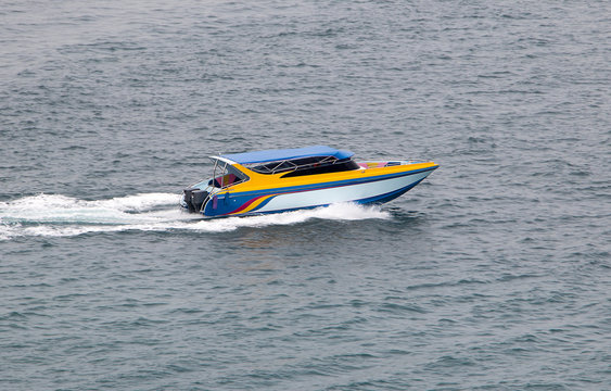 A motorboat rides quickly on the sea.