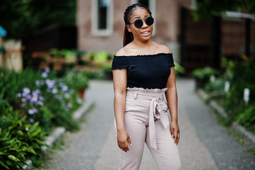 Stylish african american woman at sunglasses posed outdoor.