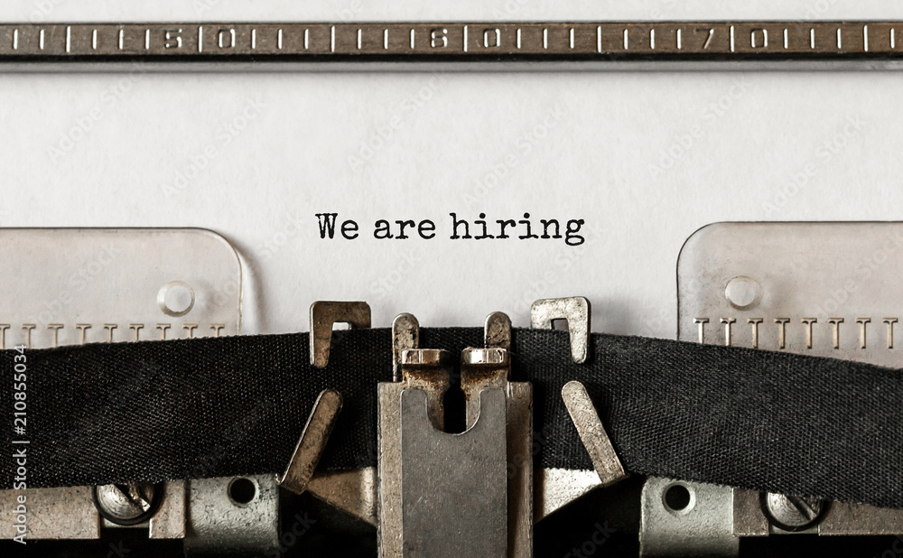 Poster text we are hiring typed on retro typewriter