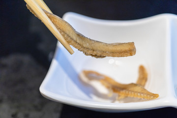 chopsticks holding fish bone senbei