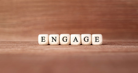 Word ENGAGE made with wood building blocks