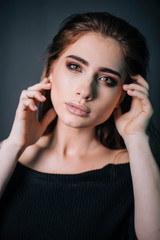 beauty portrait. Studio portrait of a beautiful girl on a gray background. Good make-up. Face close-up