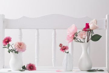 pink roses on vintage wooden white shelf