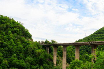 Fototapeta na wymiar Bridge over the precipice in the mountains near Ananuri fortress, Georgia
