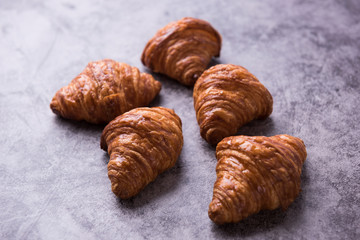 Fresh croissant on a dark table.
