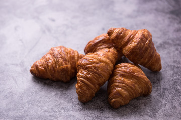Fresh croissant on a dark table.