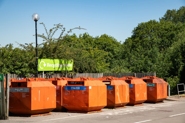 recycling area for bottles cans and cardboard in car park