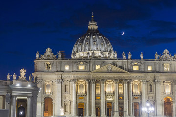 Fototapeta na wymiar St Peter's basilica illuminated at night in Rome, Italy
