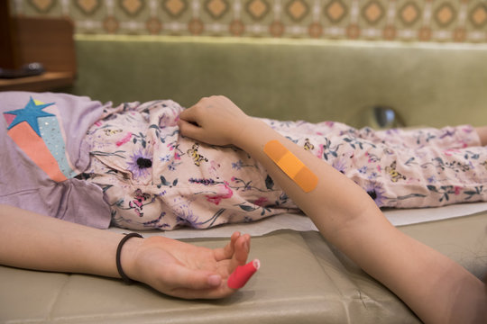 Sisters with colorful bandaids in doctor's office