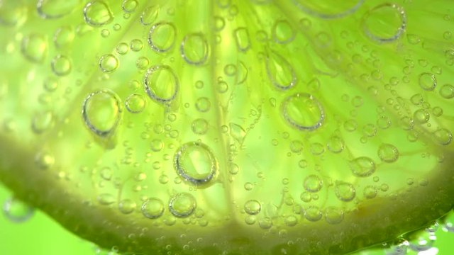 Lime. Slices of juicy lime. Mojito cocktail closeup. Slow motion 4K UHD video 3840x2160