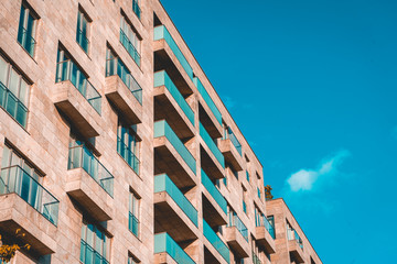 modern apartment building with green balcony and copy space on the right side