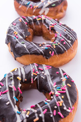 Closeup of donuts with sprinkles isolated on white