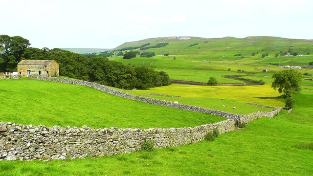 Rural landscape with an old stone barn in the heart of England's Yorkshire Dales, near the town of Hawes.