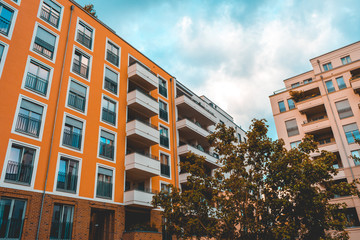 red and orange facaded apartment house with blue square windows