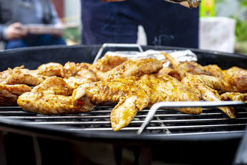 Chicken wings are cooked on the grill, close-up.