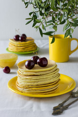 Plate with homemade fritters with berries and honey for breakfast