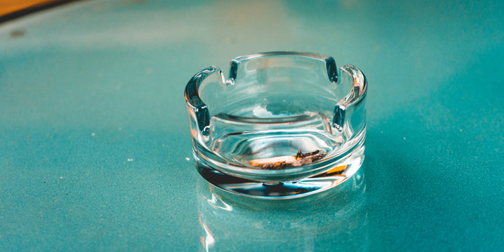 glass ash tray on a green table