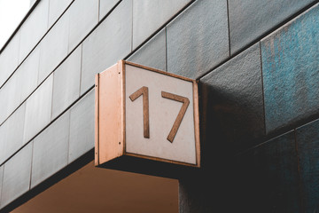 number 17 door sign on darken facade