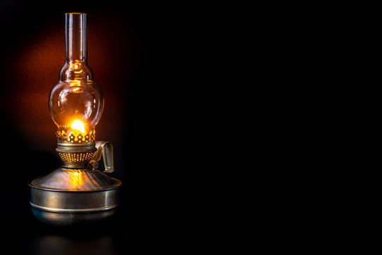 Kerosene lamp isolated on a black background, copy space.