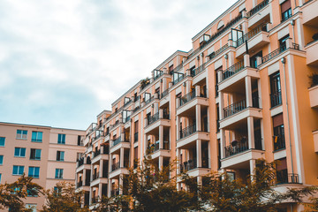 Fototapeta premium orange apartment buildings in a row with copy space in the sky