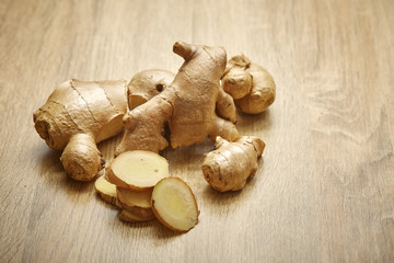 Ginger root sliced on wooden table